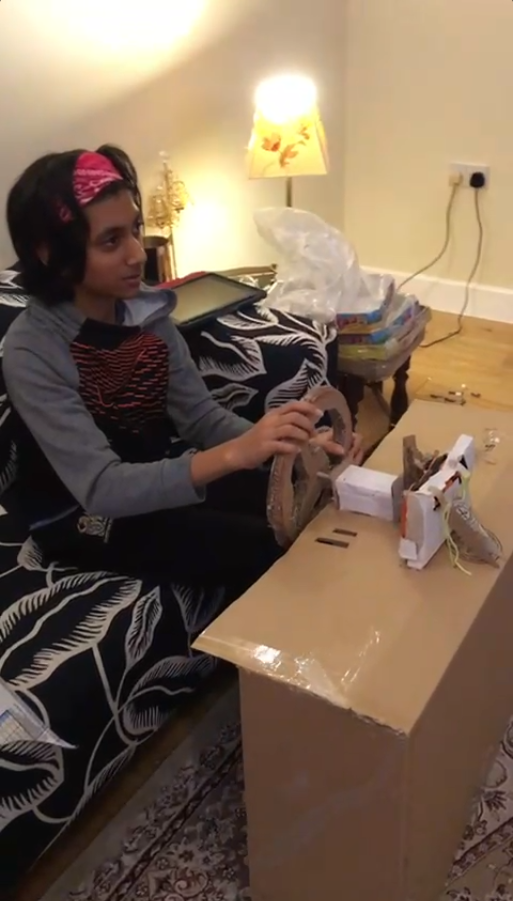 Mitul testing the cardboard steering wheel prototype